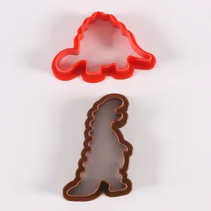 Juego de dos cortadores de galletas de plástico con forma de dinosaurio para repostería.