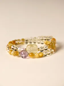Detail of a double-layered citrine and tiger's eye beaded bracelet with amethyst