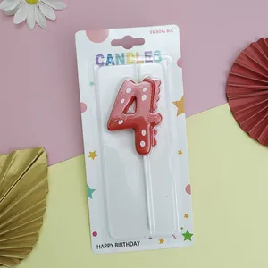 Detailed view of a red dinosaur number 4 birthday candle in retail packaging