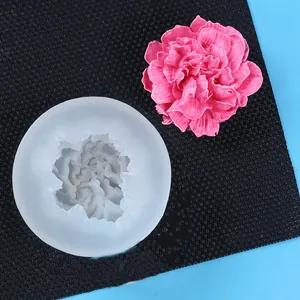 Detailed view of carnation flower silicone mold with finished pink plaster carnation