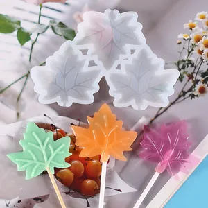 Detail view of maple leaf silicone lollipop mold with colorful finished candies