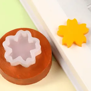 Close-up of a flower-shaped silicone fondant mold with a yellow finished piece