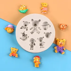 Close-up view of circular silicone mold featuring various teddy bear shapes and resin samples