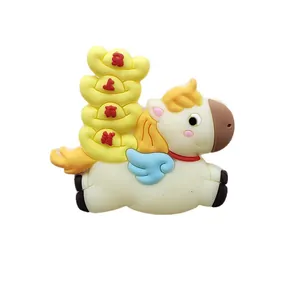 Adorable soft PVC pony cake topper with stacked gold ingots for wealth and luck