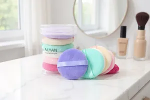 Detail shot of six multi-colored ALYAN soft powder puffs in a transparent storage tube