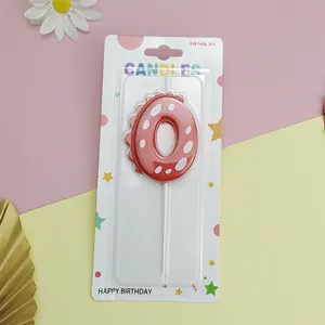 Red dinosaur number 0 birthday candle in retail packaging for kids party cake decor