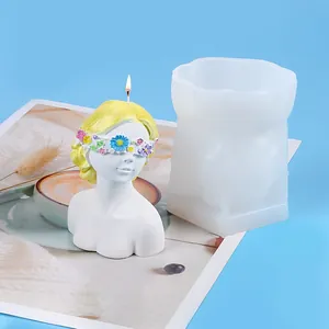 Detailed view showing the translucent silicone mold and finished girl bust candle