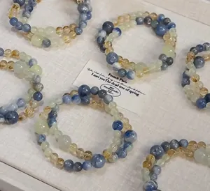 Detailed macro view of handmade blue kyanite and yellow citrine beaded stretch bracelets