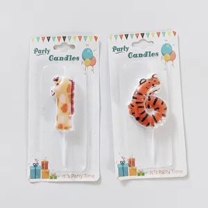 Detailed view of giraffe and tiger numbered party candles in their retail packaging.