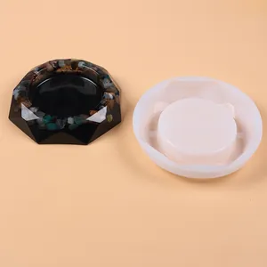 Large white silicone mold for DIY resin ashtray shown with finished stone-embedded sample