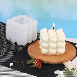 Detail view of heart bubble cube silicone mold with a lit finished candle