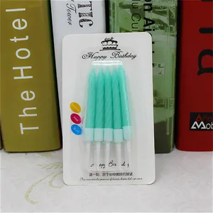 Detailed macro view of Tiffany blue spiral birthday candles with holders in packaging box.