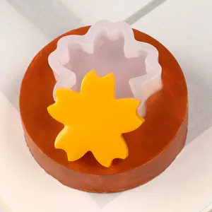 Detailed view of daisy flower silicone mold with a yellow fondant sample for cake decorating.