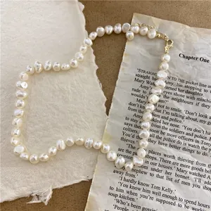 Close-up of baroque natural pearl necklace on vintage manuscript paper