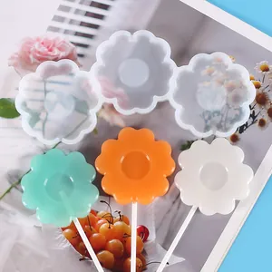 Detail showing flower-shaped silicone lollipop mold with finished colorful samples
