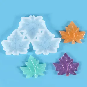 Detail showing a 3-cavity maple leaf silicone mold with colorful resin samples.