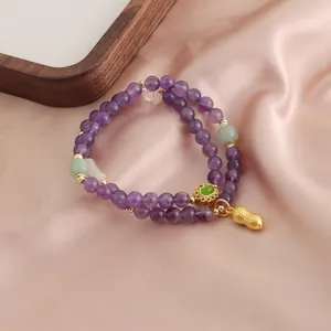 Bracciale a doppio filo in ametista naturale con ciondolo arachide dorato e giada
