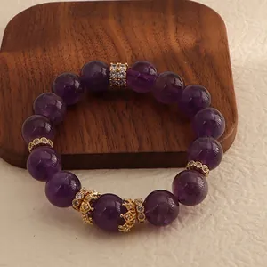 Close-up of natural Uruguay amethyst bracelet with golden crown spacers and crystals.