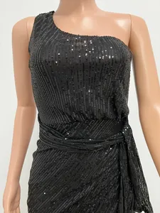Detailed view of elegant black one-shoulder sequin evening dress with pleated waist.
