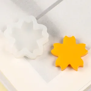 Detail view of flower-shaped silicone mold with a yellow finished fondant piece