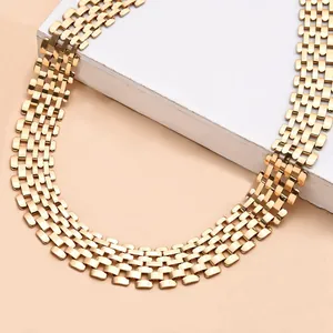 Detailed close-up of a gold-toned punk hip hop wide multi-row link chain necklace.