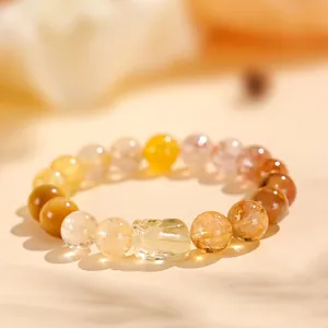 Elegante pulsera de cristal amarillo y cuarzo rutilado dorado con dije de Pixiu