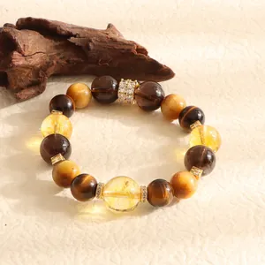 Macro detail shot of natural tiger's eye and yellow crystal beaded bracelet with gold spacers