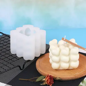 Detail view of a bubble heart silicone mold showing the mold and a finished white candle