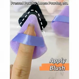 Detail of a purple triangular flocked makeup puff with a blue finger ribbon strap