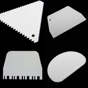 Professional set of four white plastic cake scrapers with serrated and smooth edges