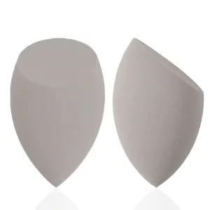 Close-up of gray teardrop and slanted-cut beauty blenders for makeup application.