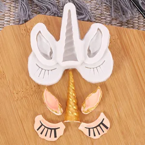 Detailed view of unicorn silicone mold set with finished horn and ears on bamboo board