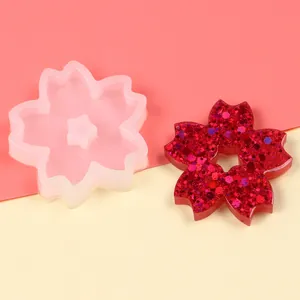 Silicone cherry blossom mold with finished glittery flower for cake decoration