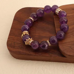 Detail view of natural Uruguay amethyst bracelet with gold crown crystal charms