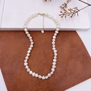 Detailed view of high-quality natural baroque pearl necklace with gold-toned clasp.