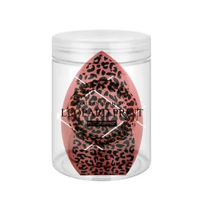 Close-up of a leopard print makeup sponge stored inside a clear transparent plastic jar