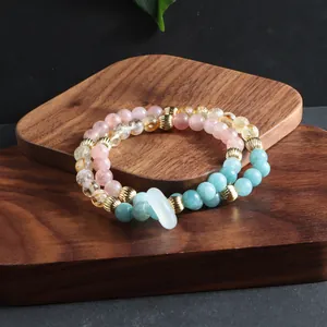 Detailed shot of multi-layer bracelet with natural sunstone, amazonite, and gold beads.