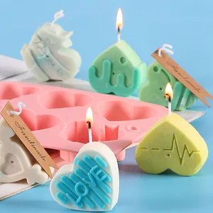Close-up detail of a pink heart-shaped silicone mold with finished DIY handmade candles