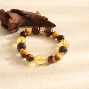 Macro view of natural yellow citrine and tiger eye stone beaded bracelet detail