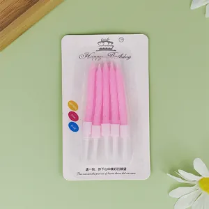 Pack of five pink spiral birthday candles for cake decoration on minimalist green background