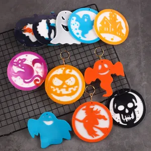 Close-up of various colorful Halloween resin pendants in ghost and pumpkin shapes