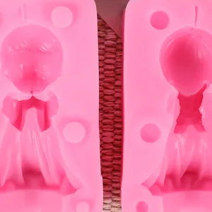 Detail view of pink silicone 3D angel boy and girl figure candle molds for craft