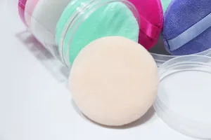 Macro view of soft colorful air cushion powder puffs in a transparent storage box set