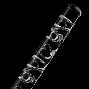 Macro detail of clear acrylic rolling pin with embossed heart patterns for fondant