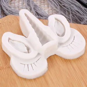 Detailed close-up view of unicorn horn and eyelash silicone mold for DIY fondant crafts