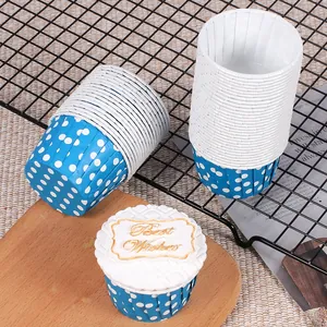 Détail de caissettes à cupcakes en papier bleu à pois et blanc dans un décor de pâtisserie.