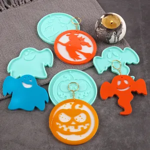 Halloween silicone molds shown with finished resin pumpkin and ghost pendants for DIY crafts