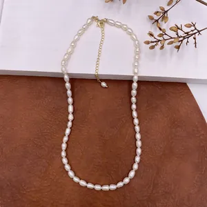 Close-up view of vintage natural baroque pearl necklace with gold adjustable chain
