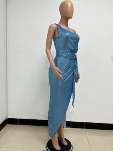 Detail view of an elegant blue one-shoulder sequin gown with pleated waist tie detail