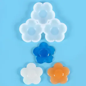 Three-cavity flower shaped silicone mold with blue, white, and orange resin samples